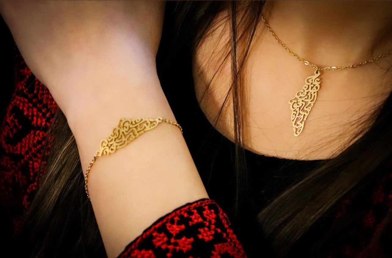 Golden Country Map Necklace Written on it (On this earth there is that which deserves life) written In Arabic Calligraphy