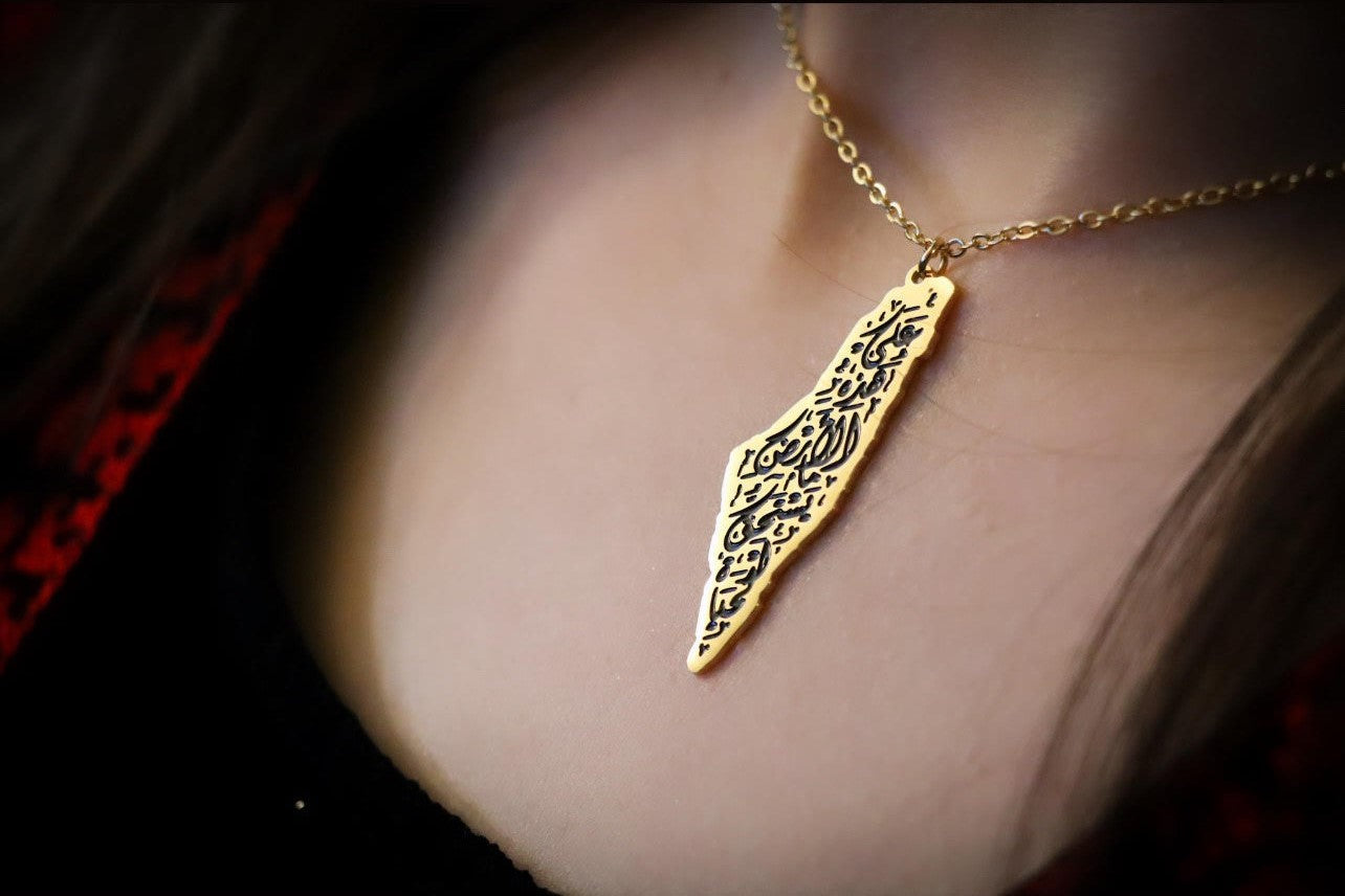 Country Map Necklace in Black Touch Written on it (On this earth there is that which deserves life) written In Arabic Calligraphy